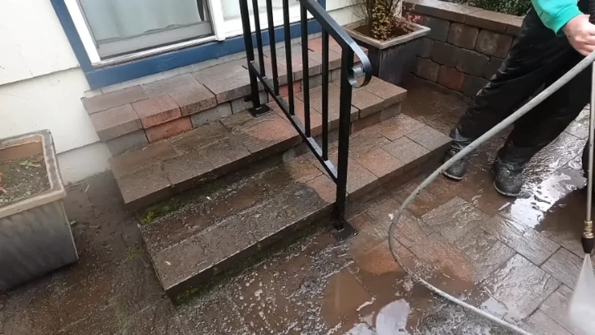 Cleaning moss and grime from paver steps at a Jacksonville, Florida property