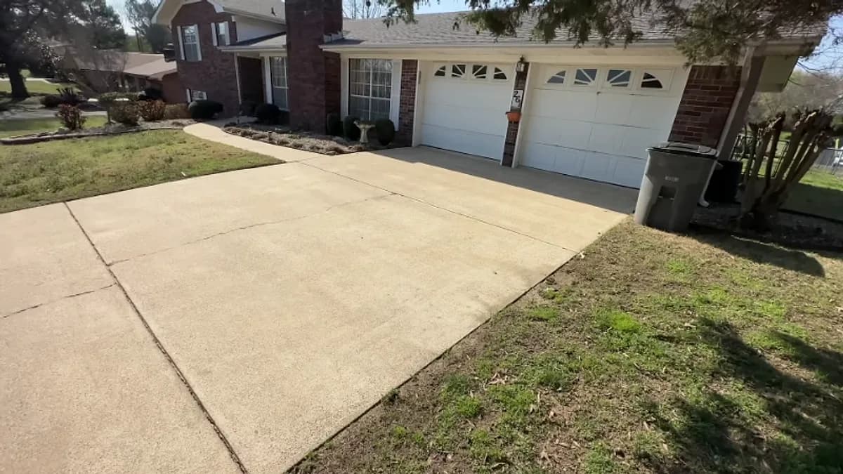 Freshly cleaned concrete driveway at a brick home in Jacksonville, Florida