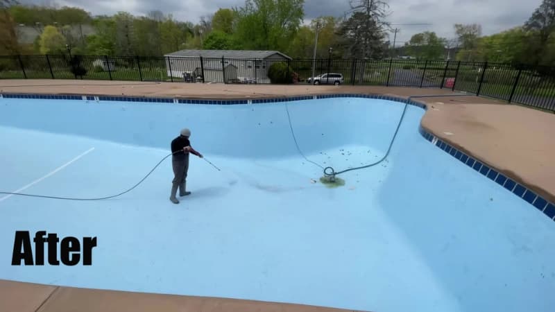 The same drained pool after washing, its pale blue floor visible again