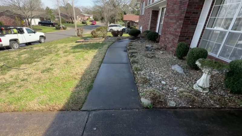Concrete walkway darkened by heavy surface staining before cleaning
