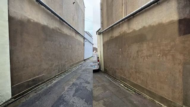 Concrete alley walls between two buildings after graffiti removal